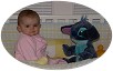 Anna-with-Disney-character-Stitch-in-crib-tired-but-smiling-033103